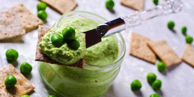 A jar of sweet green pea dip, with crackers