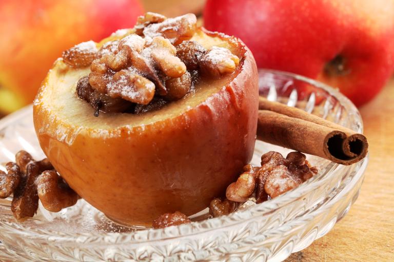 a baked apple stuffed with walnuts and raisins